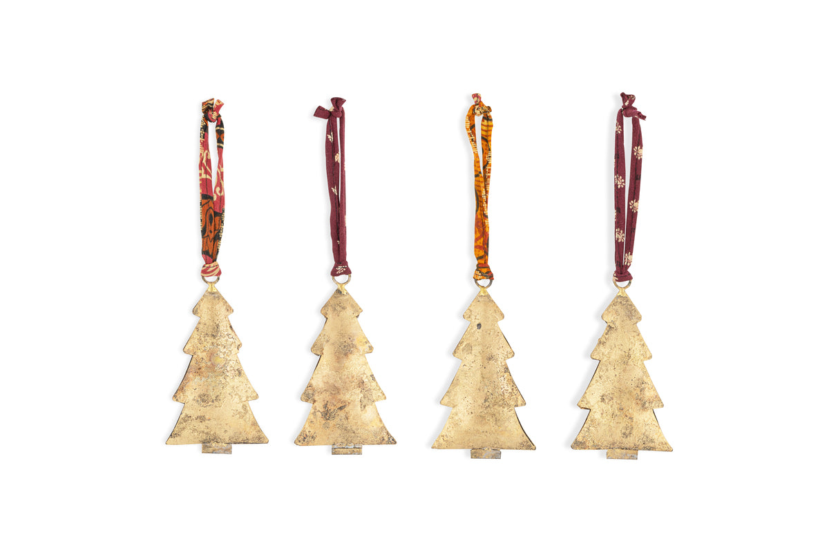 Four Mishti Tree Baubles in antique brass by nkuku are displayed in a row, each iron ornament hanging from a unique ribbon. The set of four features a rustic, weathered finish and stands out against a plain white background.