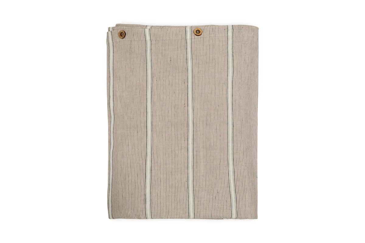 The nkuku Mora Hemp & Cotton Duvet Cover in stone grey is shown folded with vertical white stripes and two brown buttons near the top edge, displayed on a white background.