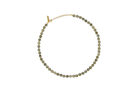 The nkuku Marai Necklace - Labradortite features a single strand of round, gray-green labradorite beads with a gold chain and adjustable clasp, displayed on a white background—an elegant accessory for any occasion.