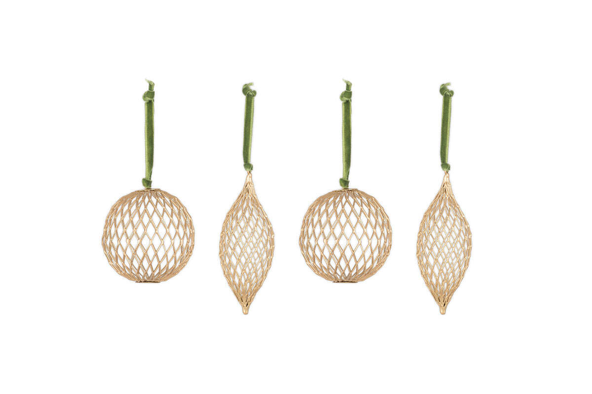 The Nirav Wire Baubles - Brass (Set of 4) by nkuku feature open lattice geometric shapes in a brass finish. Hanging from green velvet ribbons, the set includes two round, one elongated pointed, and one wide pointed bauble.
