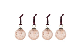The nkuku Nishan Pinched Baubles - Copper (Set of 4) features four round, recycled glass baubles with a speckled vintage finish and burgundy velvet ties—perfect festive decorations for your holiday home.