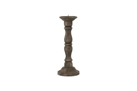 The Nayati Rustic Wood Pillar Candle Stick by nkuku features a tall, dark-stained sustainable mango wood design with a rounded base and ornate column. It has a flat top with metal spike, perfect for rustic decor. Shown on a plain white background.