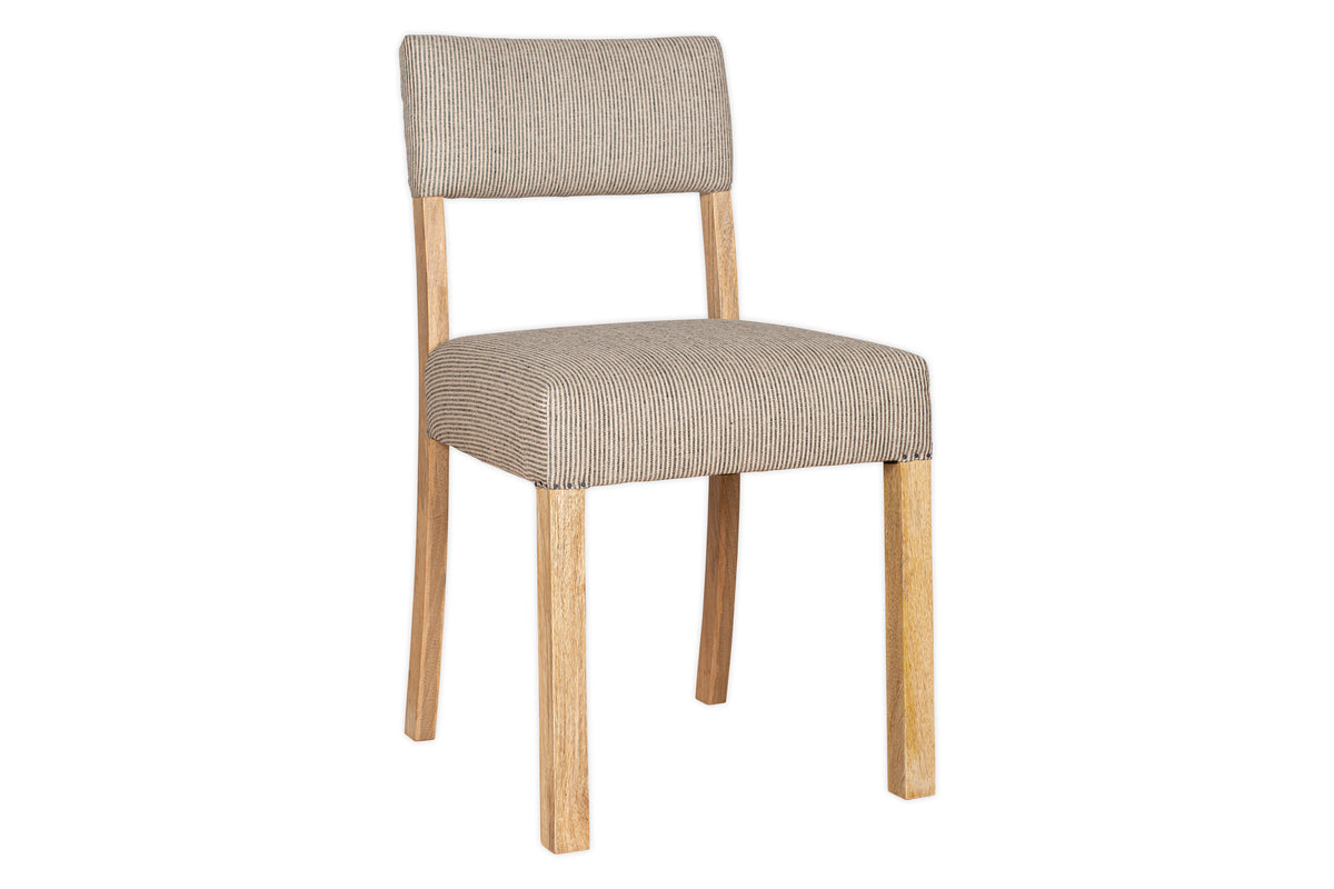 The nkuku Nadeeka Linen Upholstered Dining Chair features a mango wood frame and cushioned seat with soft grey, textured linen upholstery on the seat and backrest, shown against a white background.