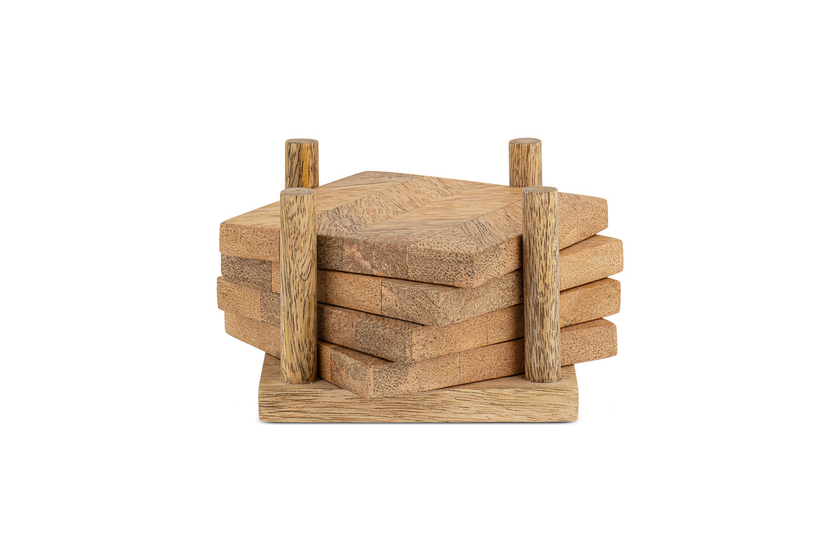 The Nalbari Coasters - Natural (Set of 4) by nkuku features four sustainable, hexagonal mango wood coasters in a light finish, neatly stacked on a square holder with two vertical posts.