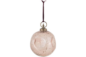 The Nishan Pinched Giant Bauble - Copper by nkuku is a round, recycled glass ornament with a speckled finish and vintage look. It hangs from a dark maroon ribbon and has a brass-colored cap and ring. Background is plain white.