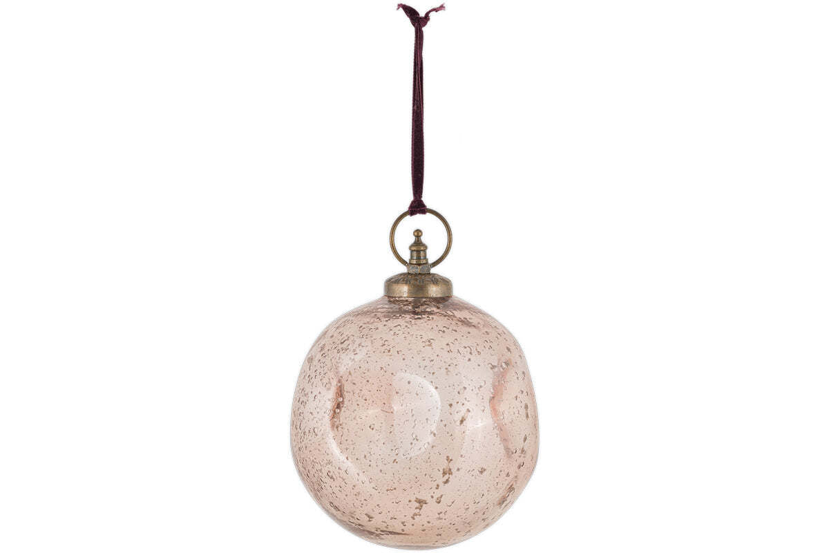 The Nishan Pinched Giant Bauble - Copper by nkuku is a round, recycled glass ornament with a speckled finish and vintage look. It hangs from a dark maroon ribbon and has a brass-colored cap and ring. Background is plain white.