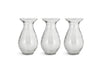 The nkuku Bapti Bud Vases – Clear (Set of 3) feature wide flared rims, narrow necks, and bulbous bodies with a textured, wavy finish. Arranged side by side, they reflect light beautifully against a plain white background.