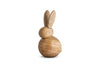 The nkuku Khara Mango Wood Rabbit Standing Decoration features a small, natural mango wood bunny with a rounded body, oval head, and tall upright ears. Its smooth finish displays the wood grain and stands angled to the right.
