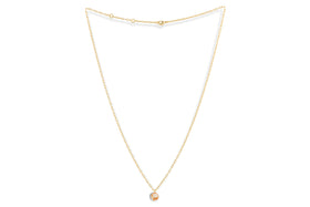 The Cerita Rhodochrosite Necklace by nkuku features a delicate gold chain and a round pink-and-white marbled rhodochrosite pendant in a simple bezel, elegantly displayed on a plain white background.