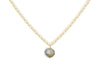 The Marai Labradorite Necklace by nkuku features a gold chain with elongated links and a central round labradorite pendant, displaying blue and brown flecks—an elegant jewelry gift.