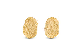 The Oya Hammered Earrings - Gold from nkuku feature an oval shape, textured matte finish, and organic outline, making them striking statement jewellery—perfect for elevating any look.
