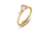 The Cerita Rhodochrosite Ring by nkuku features a textured gold-plated open band with hammered finish, capped ends, and a round rhodochrosite stone with orange marbling, photographed on a white background.