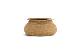 The nkuku Rana Short Basket - Natural & Moss features a wide, round woven design with a slightly tapered opening and flared rim. Crafted from light brown seagrass fibers, it brings textured charm to any natural home decor.