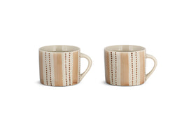The nkuku Patthar Mug - Cream & Clay - Small (Set of 2) features two beige ceramic mugs with handles, accented by hand-painted brown dots and tan stripes for an earthy, artisanal look. Both are shown side by side against a plain white background.