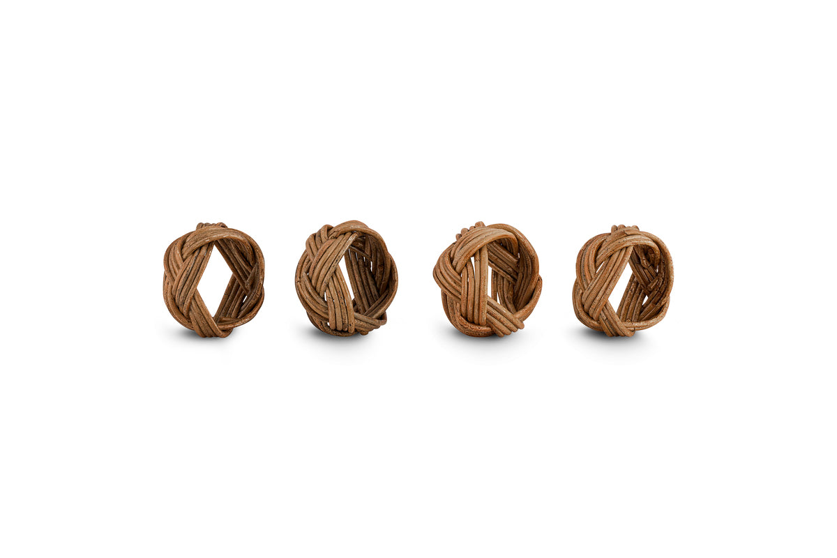 The Bersama Rattan Napkin Rings by nkuku come as a set of four handcrafted, natural round rings, displayed side by side on a white background—ideal for adding artisanal charm to your table decor.