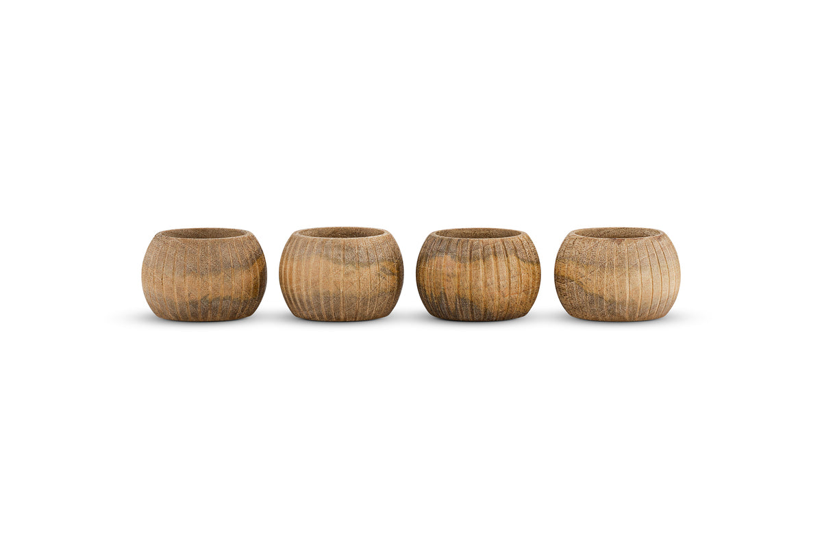 The nkuku Vivan Napkin Rings - Natural - Set of 4 features small, rounded wooden rings with a natural finish and unique wood grain, bringing handcrafted charm to your table decor.