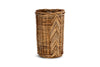 The nkuku Bersama Rattan Utensil Holder - Natural is a tall, cylindrical basket with a chevron design and tightly woven pattern, perfect for stylish kitchen storage. Its natural brown rattan highlights craftsmanship against a white background.