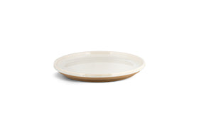 The Edo Side Plate - Terracotta by nkuku features a shallow, round stoneware design with a glossy white interior and matte, unglazed light brown base—minimalist tableware from the Edo collection, shown on a white background with a soft shadow.