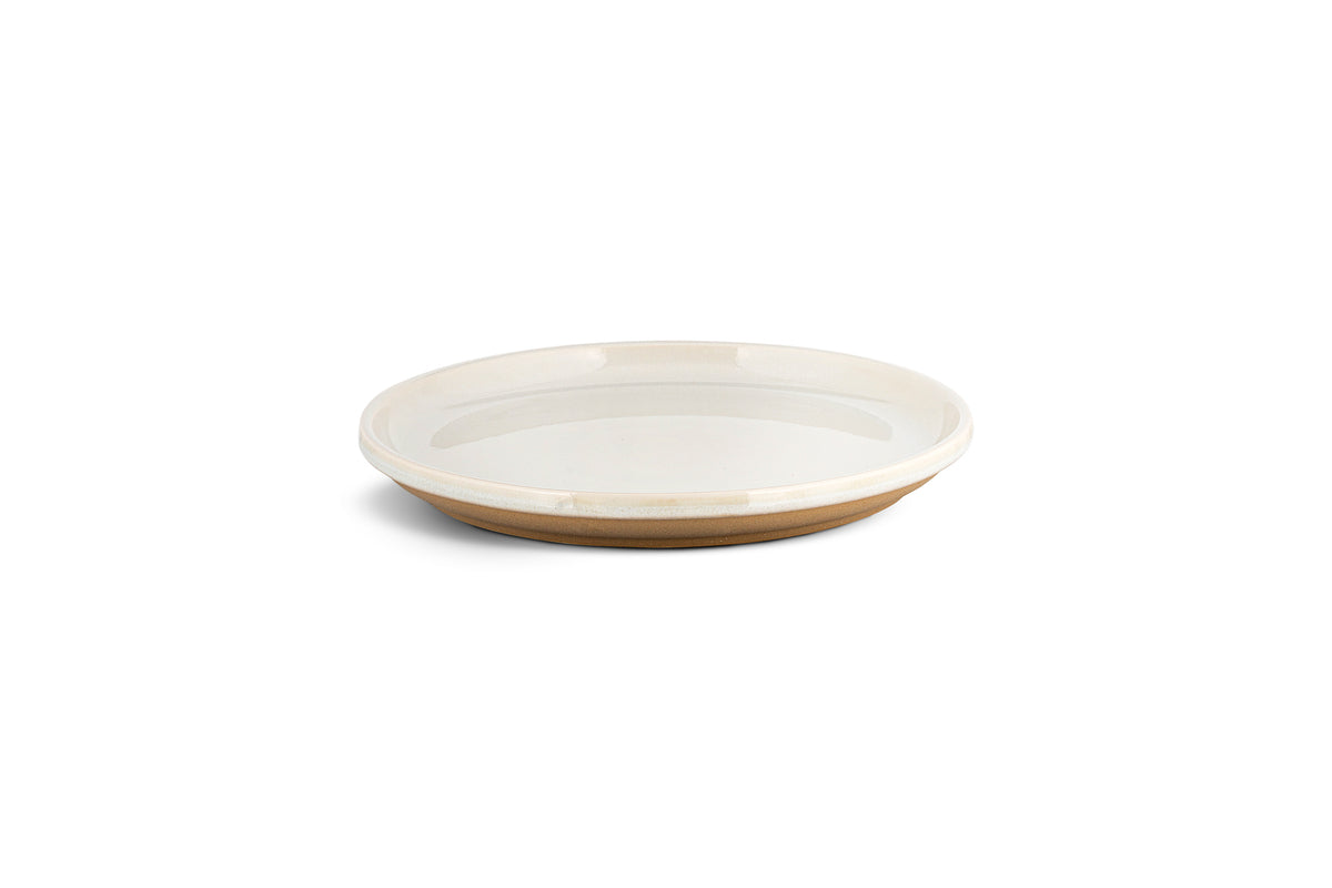 The Edo Side Plate - Terracotta by nkuku features a shallow, round stoneware design with a glossy white interior and matte, unglazed light brown base—minimalist tableware from the Edo collection, shown on a white background with a soft shadow.