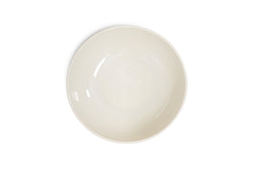 The Edo Pasta Bowl - Terracotta by nkuku is displayed centered on a white background. Its off-white ceramic has a smooth, glossy finish and minimalist, unadorned design, showcasing light reflections for an elegant look.