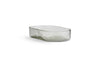 The Ilcoso Recycled Hammered Glass Soap Dish by nkuku features a clear, oval shape with textured sides and a smooth rim. Its subtle tint and handcrafted look make this unique recycled glass piece a stylish bathroom accessory.