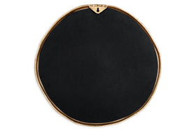 The nkuku Mchanga Organic Shape Mirror features a round, irregular black design with a slim antique brass border, a keyhole hanger at the top, and a smooth, subtle matte surface—all set against a white background.