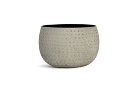 The nkuku Laoko Planter in olive grey features a subtle dotted texture, wide opening, and dark interior—ideal for modern spaces. Its minimalist design adds contemporary style to any indoor setting.