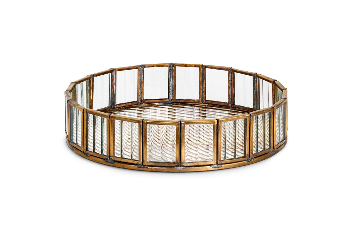 The Ruaka Glass Vanity Tray by nkuku features a gold-tone brass frame with vertical rectangular antique mercury glass panels and a mirrored base with a geometric zigzag pattern, making it an elegant vintage-inspired jewellery holder.