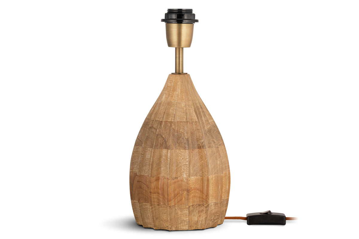 The nkuku Awaa Mango Wood Bedside Table Lamp features a rounded, grooved mango wood base in a natural finish with a brass-colored neck. No lampshade is included, and it has an electrical cord with a black switch.