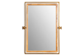 The Mar Swivel Wall Mirror by nkuku features a rectangular mango wood mirror set within a slim antique brass frame. Two horizontal gold brackets per side allow the natural wood frame to swivel, creating a striking industrial look.