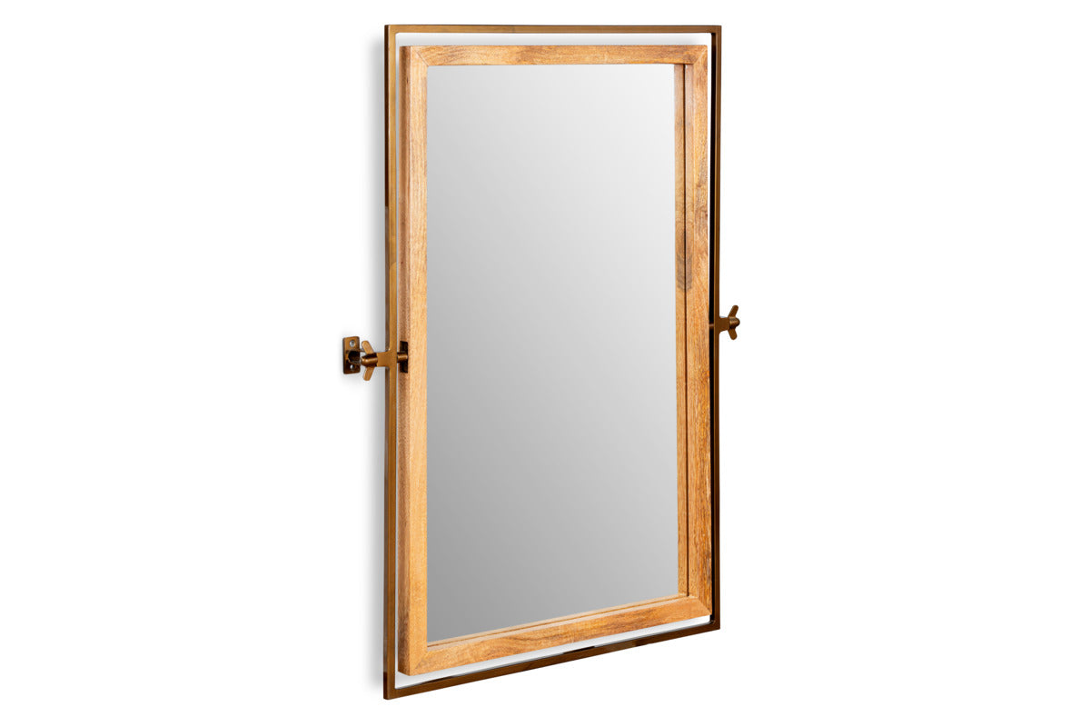 The Mar Swivel Wall Mirror by nkuku features an antique brass and natural wood frame with left-side hinges, allowing it to swing open like a window—adding a unique, functional touch to any space.