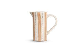 The Patthar Jug - Cream & Clay - Small by nkuku features hand-painted beige stripes and dotted lines on white ceramic, a curved handle, and a narrow spout—an eye-catching addition to your tableware collection. Displayed on a plain white background.