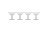 The nkuku Sooraj Champagne Coupe set includes four clear glasses with vintage charm, featuring wide, shallow bowls, short stems, and sturdy round bases. They’re arranged in a row against a plain white background.