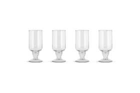 The Sooraj Large Glass - Clear (Set of 4) by nkuku features elegant, wide-based glass goblets with tall cylindrical bowls, perfectly arranged against a white background—ideal for stylishly serving summer drinks.