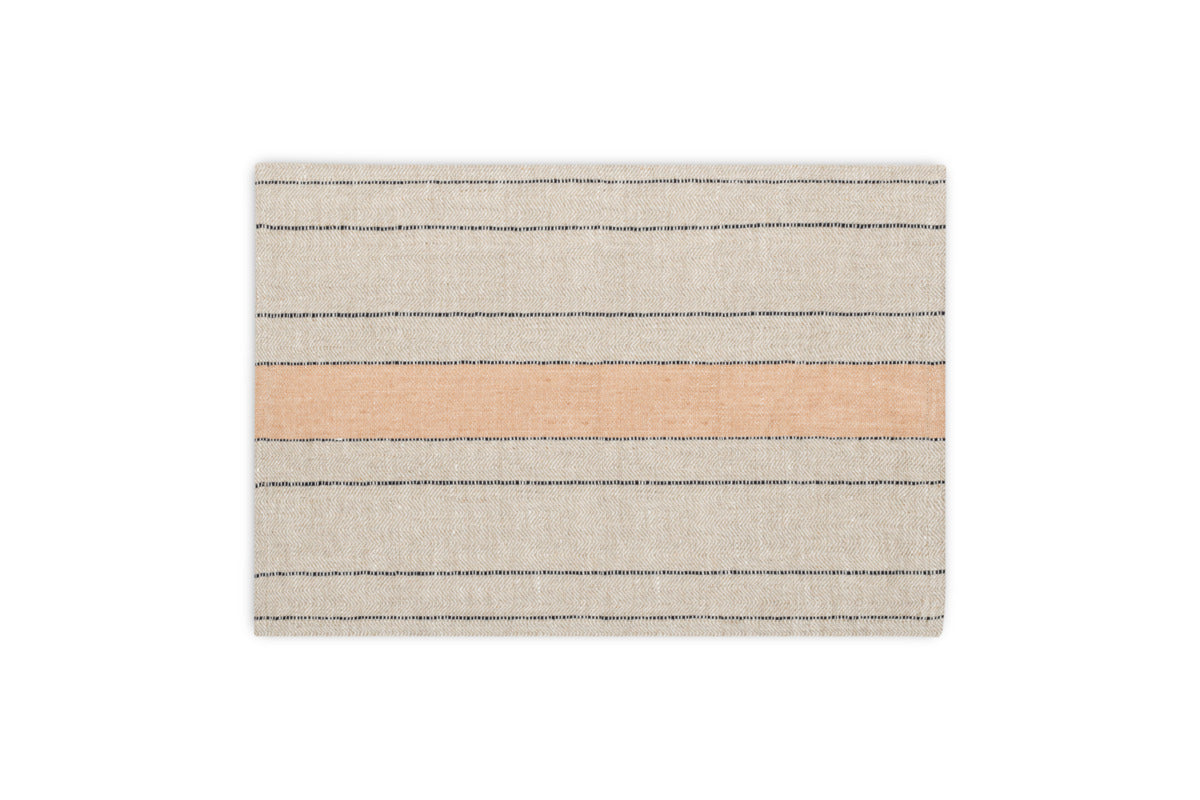 The Buna Placemats - Clay by nkuku are rectangular beige placemats with thin horizontal black lines and a wide peach stripe, offering a simple, modern look that adds minimalist style to any table setting. Set of 2.