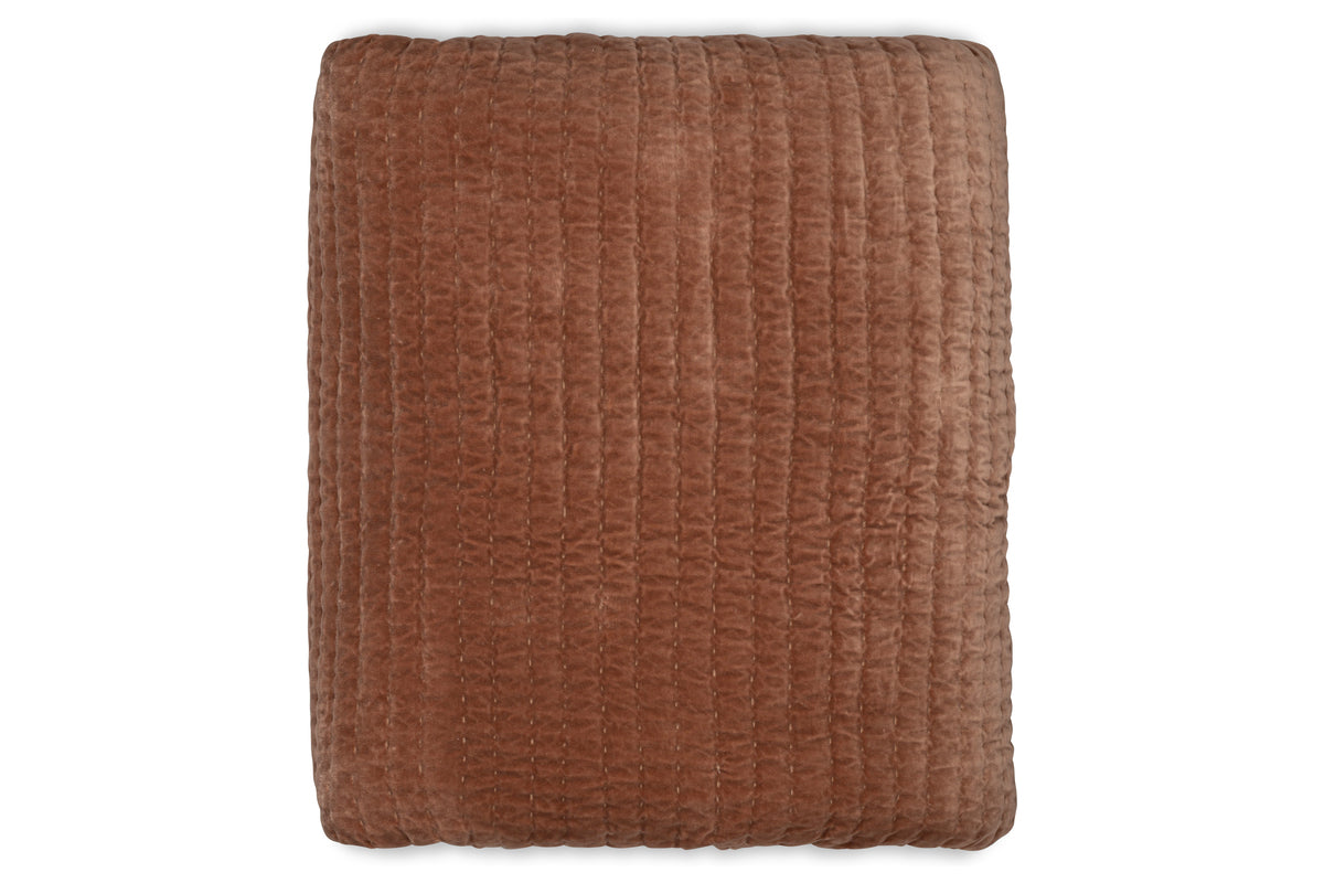The Nidra Velvet & Linen Bed Quilt - Rust by nkuku is shown folded from above on a white background, featuring soft brown cotton velvet with a grid-stitched pattern—ideal for King or Super King beds.