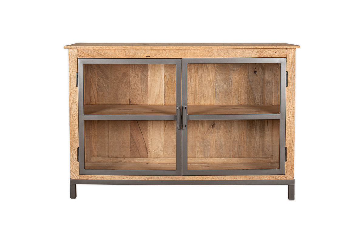 The nkuku Nirvi Mango Wood & Iron Sideboard - Black features two glass doors, metal frame accents, an interior shelf, and stands on four short metal legs against a white background.