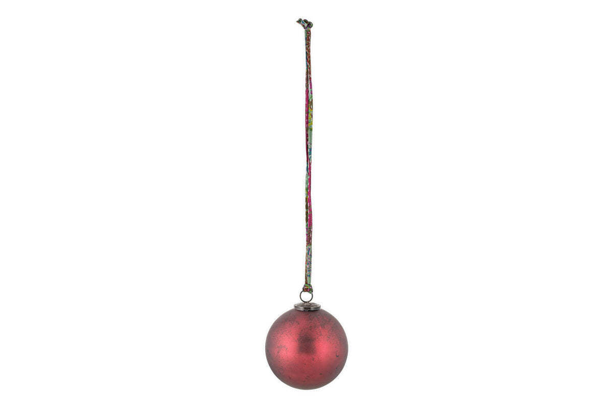 The nkuku Oko Giant Bauble - Matt Bordeaux features a slightly weathered red finish and a small metal cap, hanging from a multicolored string. Its elegant design makes it a charming addition to any festive display.