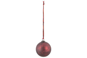 The nkuku Oko Giant Bauble - Matt Bordeaux features a single, round, dark red ornament with a textured matte finish hanging from a patterned red string, ideal for adding festive style to your Christmas decorations.