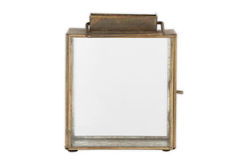 The nkuku Obi Mini Table Lantern in antique brass features a rectangular metal and glass design with a top handle, hinged glass door, and rustic finish—ideal for adding candlelight charm to any space. Shown against a white background.