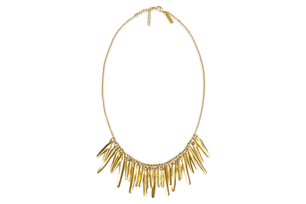 The Omuti Necklace - Gold by nkuku features a delicate gold chain with multiple elongated, pointed pendants in a chic fringe design—an effortlessly stylish piece for any party-ready look.