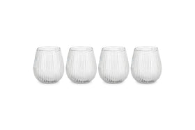The nkuku Otuba Tumbler - Clear (Set of 4) features four ribbed, recycled glass tumblers arranged in a row on a white background, bringing elegant tableware style to any setting.