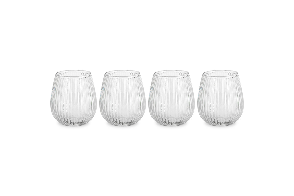 The nkuku Otuba Tumbler - Clear (Set of 4) features four ribbed, recycled glass tumblers arranged in a row on a white background, bringing elegant tableware style to any setting.