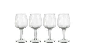 The Otuba Wine Glass - Clear (Set of 4) from nkuku features four recycled glass wine glasses with vertical ribbing, displayed in a row against a white background.