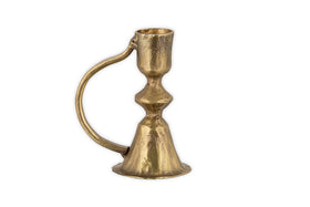 The Prema Candle Holder by nkuku features antique brass with a curved handle, flared base, and subtle hammered finish, shown against a white background.
