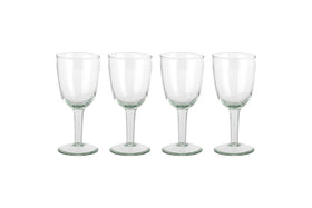 The nkuku Pani Wine Glass - Clear (Set of 4) features four durable glasses in a row on a plain white background, ideal for everyday dining.