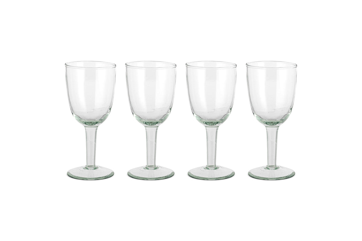The nkuku Pani Wine Glass - Clear (Set of 4) features four durable glasses in a row on a plain white background, ideal for everyday dining.