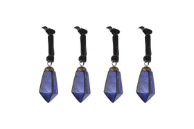 The nkuku Ratnam Baubles - Indigo - Small (Set of 4) feature faceted deep blue crystal points with an antique glass finish on black velvet ribbons. Each ribbon is topped with a black crow figurine for a gothic, elegant look.