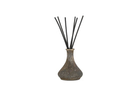 The nkuku Cedarwood & Fig Reed Diffuser features a rustic, speckled ceramic bottle with a narrow neck and black reeds, ideal for spreading a soothing cedarwood scent.
