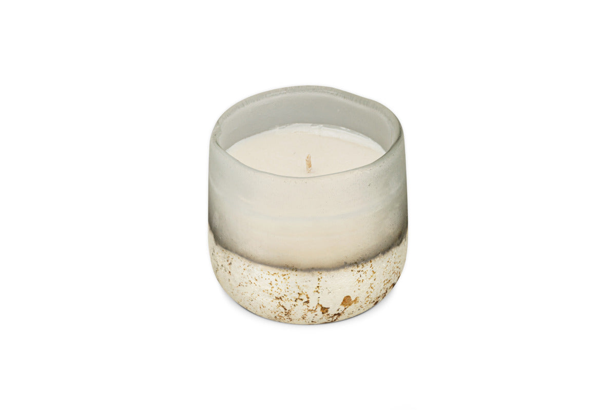 A nkuku Cardamom & Amber 1 Wick Scented Candle in a frosted glass holder with a gold-speckled base, displayed on a plain white background.